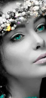 Grayscale portrait of woman with teal eyes and floral crown.