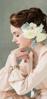 Elegant portrait of a woman with floral headpiece in soft peach tones.