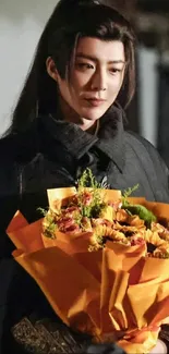 Elegant portrait with orange flowers bouquet in dark ambiance.