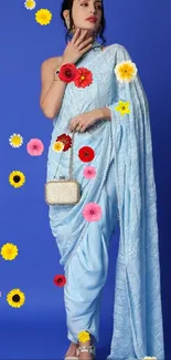 Woman in blue saree surrounded by colorful flowers.