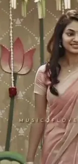 Woman in pink sari with a floral backdrop.