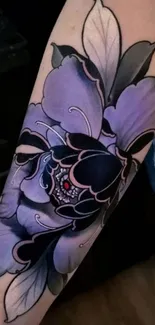 Purple flower tattoo with intricate black details on the arm.