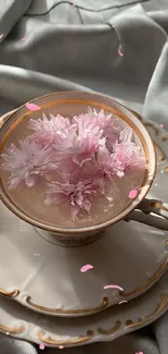 Elegant teacup with pink flowers on silk.