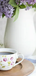 Elegant floral tea setting with lilacs in a white pitcher.