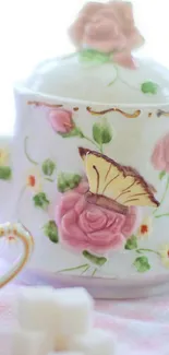 Elegant teapot wallpaper with roses and butterfly design in pastel colors.