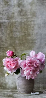 Elegant pink roses in a rustic vase with a textured khaki background.