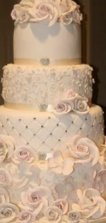 Three-tier floral wedding cake with roses.