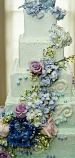 Elegant white wedding cake with floral decoration.