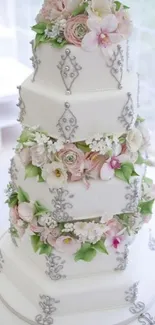 Elegant tiered wedding cake with floral accents.