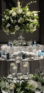 Elegant wedding table with floral centerpiece and sleek glassware.