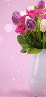 Elegant bouquet of flowers in white vase on pink background.