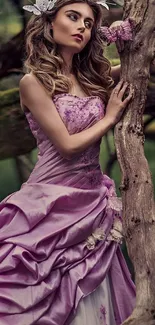 Woman in lilac dress leaning against tree in forest background.