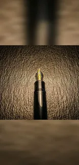 Elegant fountain pen on brown textured background wallpaper.