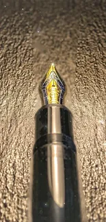 Elegant fountain pen with gold tip on a textured background.