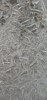 Close-up of elegant frost crystal patterns on a gray textured background.