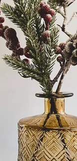 Elegant amber glass vase with frosted pine and berries.