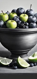 Fruit bowl with blueberries and green apples on a grey background.