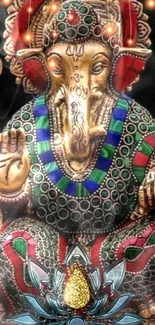 Intricate Ganesha statue with colorful, decorative jewels.