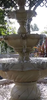 Beautiful garden fountain in sunshine.