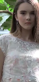 Young woman in lace dress in garden setting.