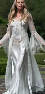 Elegant woman in white dress strolling in a vibrant garden.