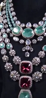 Luxurious gemstone necklace with emeralds and rubies on a black background.
