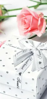 Polka dot gift box with pink roses and silver ribbon.