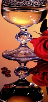 Elegant glass and red rose reflecting warm glow on mobile wallpaper.