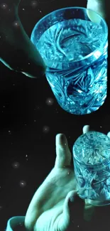 Hands holding intricately designed crystal glass with dark cyan tones.