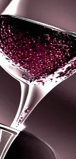 Stylish wallpaper of a wine glass filled with red wine, showcasing elegance and luxury.