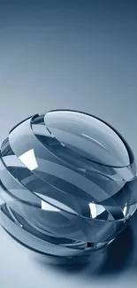 Elegant glass sphere on blue gradient wallpaper.