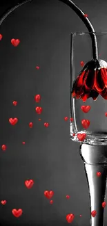 Artistic wallpaper featuring a glass with a red flower against a gray background.