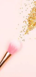 Pink makeup brush with golden glitter on light pink background.