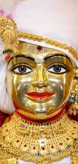 Gold adorned statue with intricate jewelry and vibrant details.