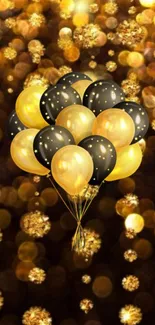 Gold and black balloons with sparkling lights on a festive wallpaper.