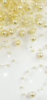 Elegant mobile wallpaper with delicate gold beads on white.