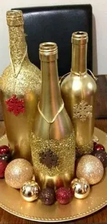 Elegant gold bottles with festive ornaments on a wooden table.