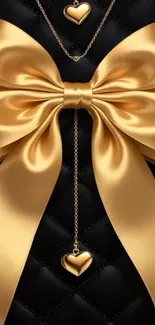 Elegant gold bow with heart pendants on a black background.