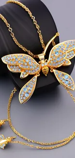 Elegant gold butterfly jewelry with blue gemstones.