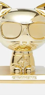 Gold cat figure with shiny metallic finish on a white background.