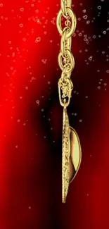 Luxurious gold chain on vibrant red background with elegant design.