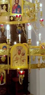 Ornate gold chandelier with religious images and glowing lights.