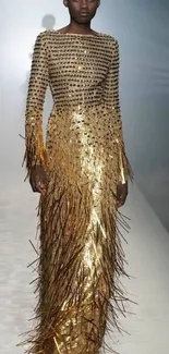 A stunning model in an elegant gold dress on the runway.