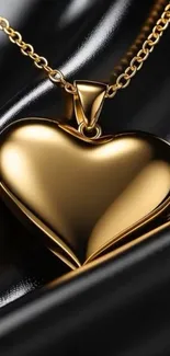 Gold heart necklace on black background wallpaper.