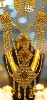 Close-up of intricate gold jewelry with geometric patterns.