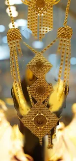 Luxurious gold jewelry with intricate design on display.