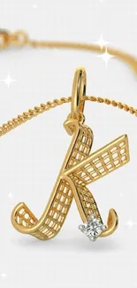 Gold letter necklace charm with diamond detail.