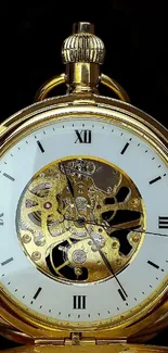 Elegant gold pocket watch with intricate details on a black background.