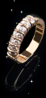 Gold diamond ring with reflection on black background.