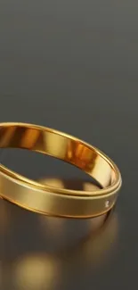 Elegant gold ring on minimalist dark background.